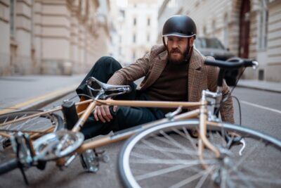 Bicycle Accident Lawyer in Lithonia | No Win, No Fee Man on ground with a bike